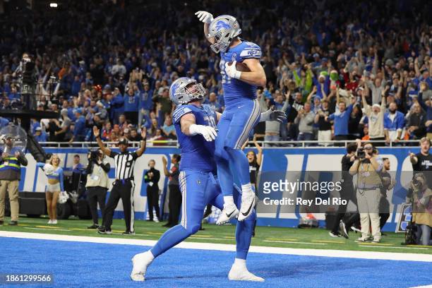 Sam LaPorta of the Detroit Lions celebrates his touchdown catch with Dan Skipper during the fourth quarter against the Denver Broncos at Ford Field...
