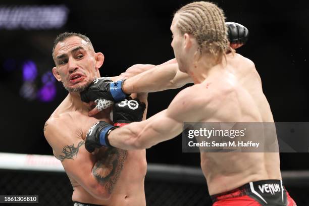 Tony Ferguson of the United States exchanges punches with Paddy Pimblett of England in a lightweight fight during the UFC 296: Edwards vs. Covington...