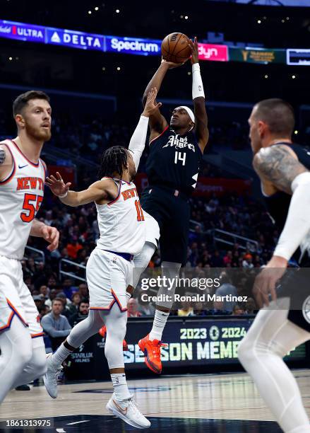 Terance Mann of the LA Clippers takes a shot against Jalen Brunson of the New York Knicks in the first half at Crypto.com Arena on December 16, 2023...