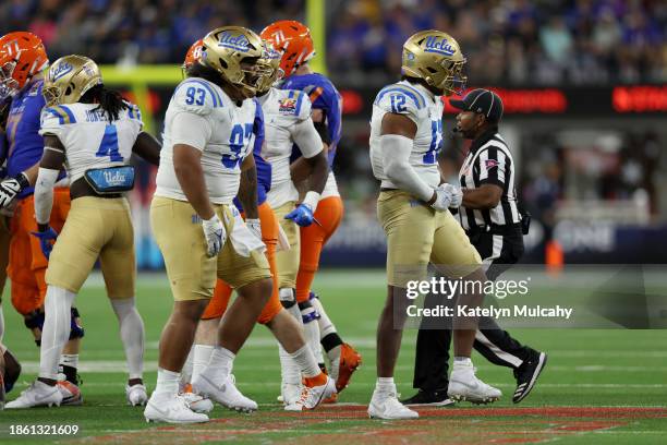 Grayson Murphy and Jay Toia of the UCLA Bruins celebrate a stop to force a fourth down in the third quarter against the Boise State Broncos during...