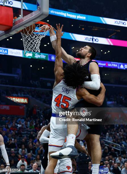 Ivica Zubac of the LA Clippers takes a shot against Jericho Sims of the New York Knicks in the first half at Crypto.com Arena on December 16, 2023 in...