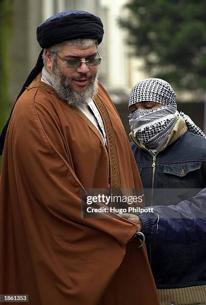 Muslim Cleric Abu Hamza Al-Masri is embraced by one of his supporters outside the Finsbury Park Mosque during Friday prayers March 21, 2003 in...