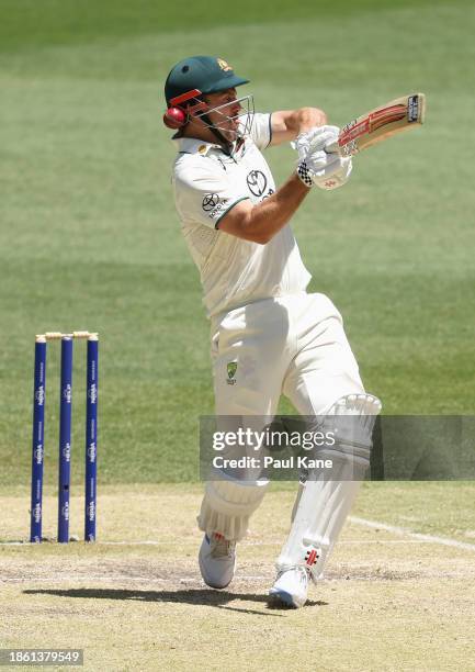 Mitchell Marsh of Australia is struck in his helmet by the ball during day four of the Men's First Test match between Australia and Pakistan at Optus...