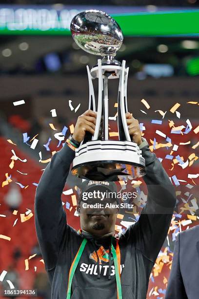 Head coach Willie Simmons of the Florida A&M Rattlers celebrates with the trophy after defeating the Howard Bison 30-26 during the Cricket...