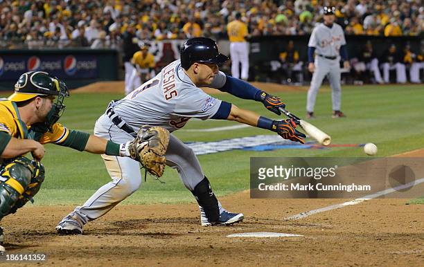 Jose Iglesias of the Detroit Tigers bunts during Game Two of the American League Division Series against the Oakland Athletics at O.co Coliseum on...
