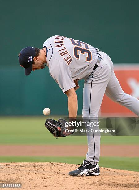 Justin Verlander of the Detroit Tigers picks a baseball up off the mound prior to Game Two of the American League Division Series against the Oakland...