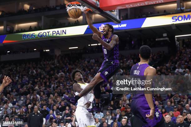 Malik Monk of the Sacramento Kings dunks the ball against Taylor Hendricks of the Utah Jazz in the third quarter at Golden 1 Center on December 16,...