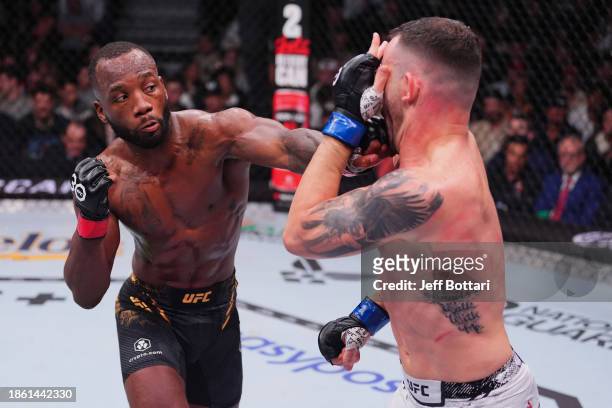 Leon Edwards of Jamaica punches Colby Covington in the UFC welterweight championship fight during the UFC 296 event at T-Mobile Arena on December 16,...