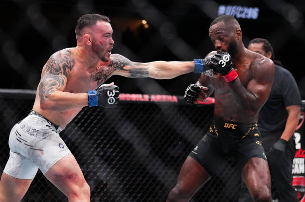 Colby Covington punches Leon Edwards of Jamaica in the UFC welterweight championship fight during the UFC 296 event at T-Mobile Arena on December 16,...
