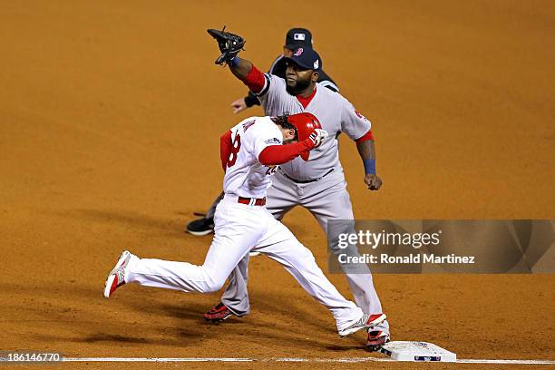 Pete Kozma of the St. Louis Cardinals is out at first by David Ortiz of the Boston Red Sox on a sacrafice moving David Freese to second base in the...