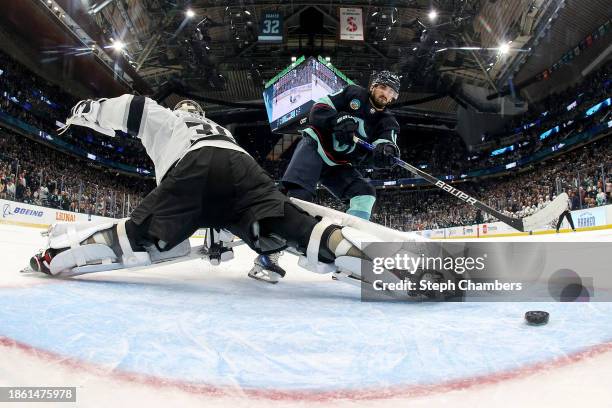 Matty Beniers of the Seattle Kraken scores a goal in a shootout against Cam Talbot of the Los Angeles Kings at Climate Pledge Arena on December 16,...