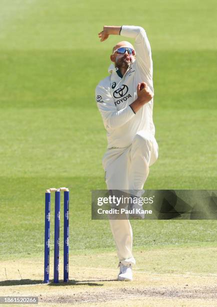 Nathan Lyon of Australia bowls during day four of the Men's First Test match between Australia and Pakistan at Optus Stadium on December 17, 2023 in...