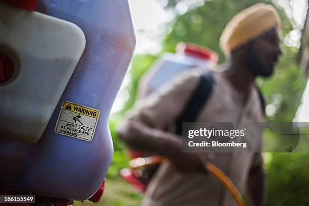 Warning sticker is displayed on the tank of crop spraying equipment on the farm of Jarnail Singh in Jajjal village, Punjab, India, on Wednesday, Aug....