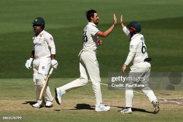 Mitchell Starc of Australia celebrates with Travis Head of Australia after dismissing Sarfaraz Ahmed of Pakistan during day four of the Men's First...