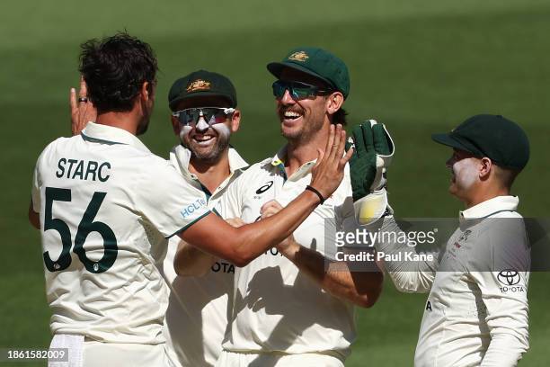 Mitchell Starc of Australia celebrates with Mitchell Marsh of Australia and team mates after dismissing Sarfaraz Ahmed of Pakistan during day four of...