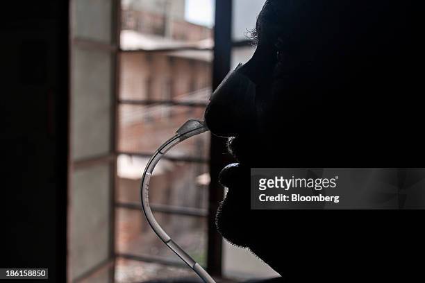 Patient breaths through a nasal cannula after surgery at the Acharya Tulsi Regional Cancer Treatment & Research Institute in Bikaner, Rajasthan,...