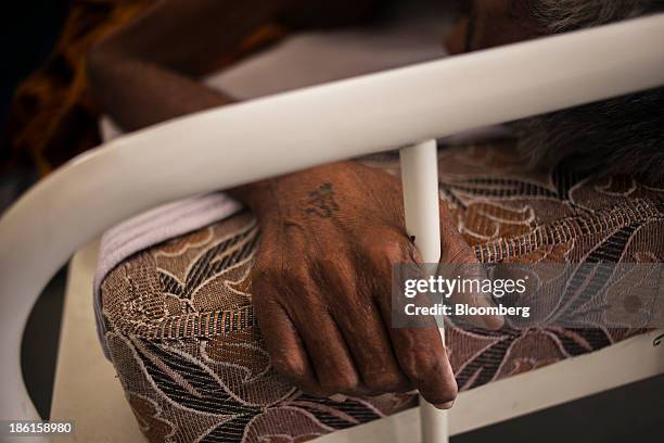 Patient holds a bed railing after a surgery in a general ward at the Acharya Tulsi Regional Cancer Treatment & Research Institute in Bikaner,...