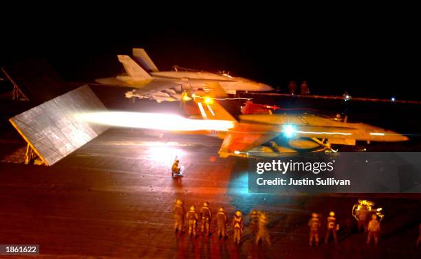 Two U.S. Marines F/A-18 Hornets launch from the flight deck of the USS Constellation as part of Operation Iraqi Freedom March 21, 2003 in the Persian...