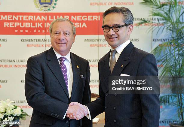 Indonesia's Foreign Minister Marty Natalegawa shakes hands with his Costa Rican counterpart Enrique Castillo Barrantes at the Foreign Ministry...