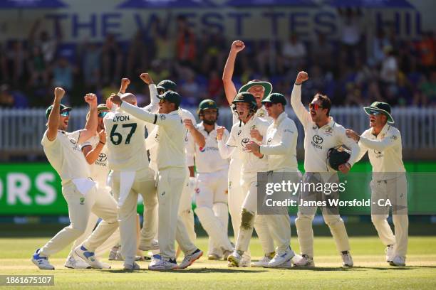 Nathan Lyon of Australia and all of the team celebrate Nathan Lyon 500th Test Wicket during day four of the Men's First Test match between Australia...