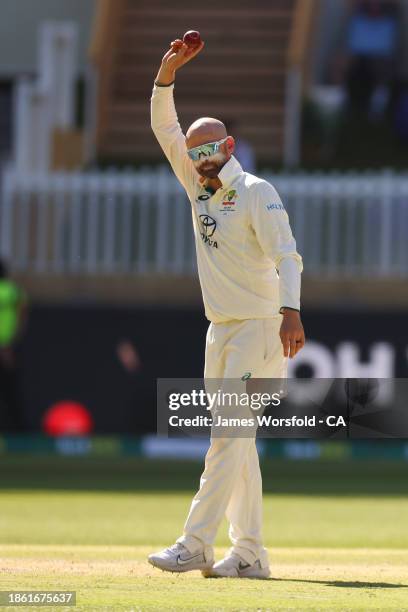 Nathan Lyon of Australia raises the ball to the crowd during day four of the Men's First Test match between Australia and Pakistan at Optus Stadium...