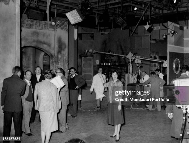 Italian actress Tatiana Farnese , in the TV studio number two, showing the scenary set for the TV series Il romanzo di un maestro. Rome, 1959.