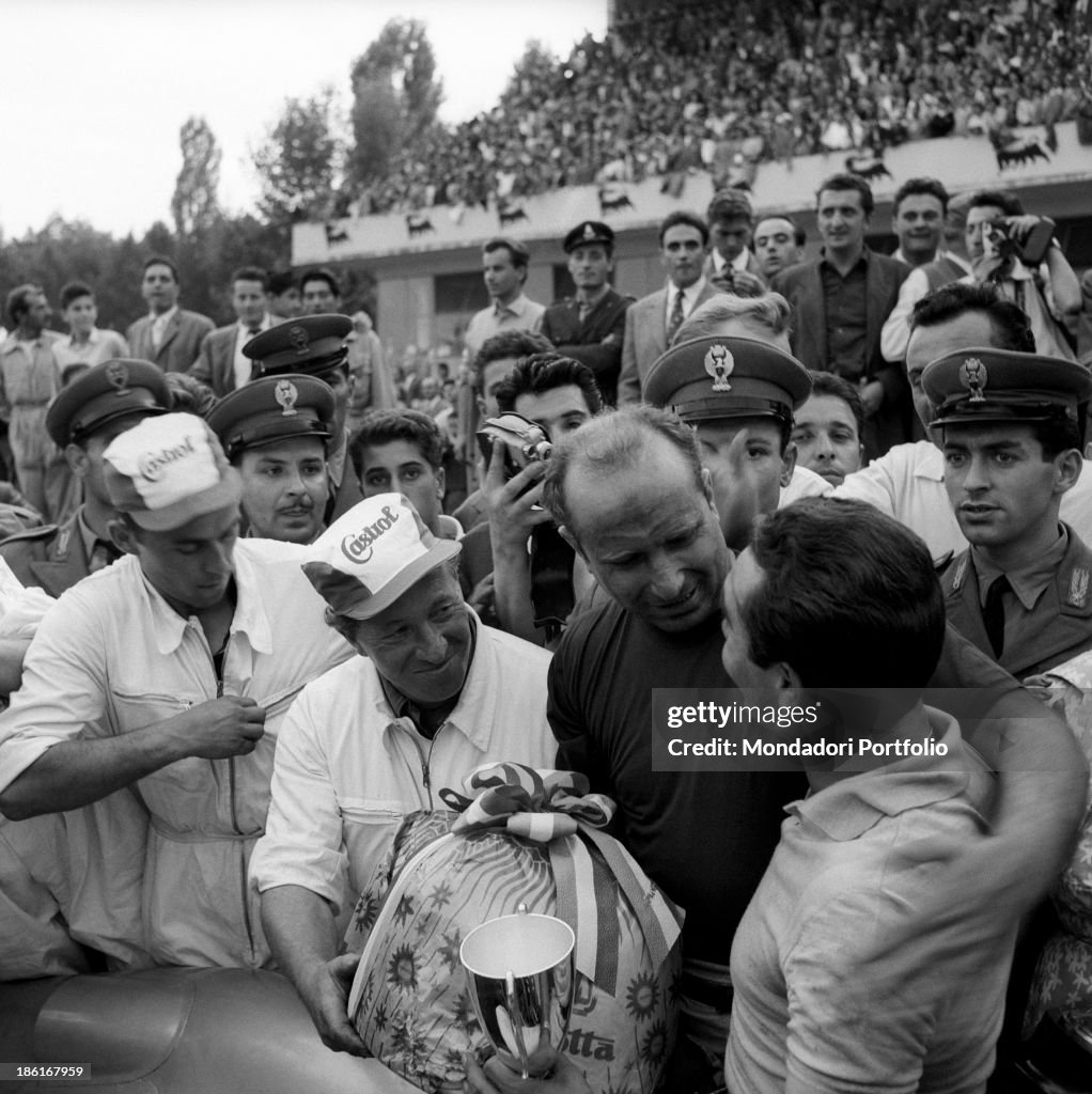 Juan Manuel Fangio hugging Eugenio Castellotti