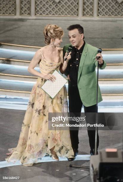 Italian showgirl Lorella Cuccarini talking to Italian singer-songwriter Enrico Ruggeri winner of the 43rd Sanremo Music Festival. Sanremo, February...