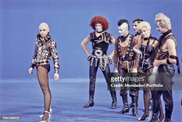 Italian TV host, actress, singer and showgirl Raffaella Carrà dancing with some dancers in the TV variety show Ma che sera. Italy, 1986.