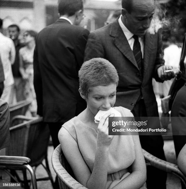 Italian actress Carla Gravina eating a sandwich at the International Film Festival. She shaved her hair for the film Five Branded Women. Venice,...