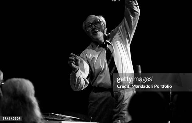 Soviet-born American cellist and conductor Slava Rostropovich conducting an orchestra raising his arm. Slava Rostropovich has been holding the role...