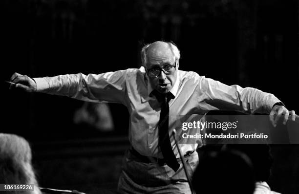 Soviet-born American cellist and conductor Slava Rostropovich conducting an orchestra opening his arms. Slava Rostropovich has been holding the role...