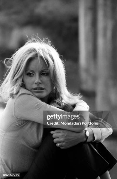 Italian TV presenter and actress Gabriella Farinon posing tucking up her legs against her chest. Italy, 1968.