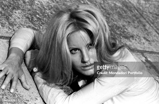 Italian TV presenter and actress Gabriella Farinon posing lying down. Italy, 1968.