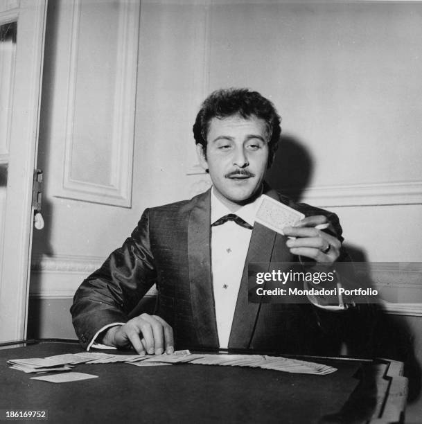 Italian singer-songwriter and actor Domenico Modugno playing cards. Domenico Modugno has just recorded the song L'avventura, theme song of the TV...