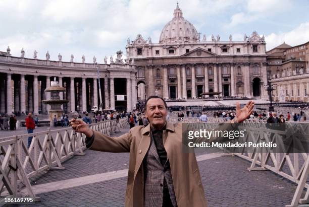 Italian actor and director Alberto Sordi opening his arms wide in front of St. Peter's Basilica. Vatican City, 1996.