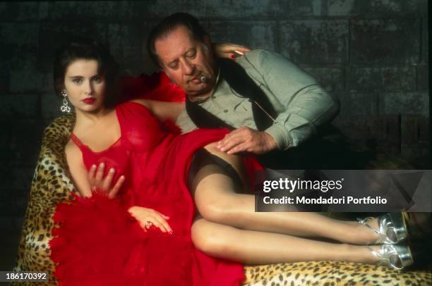 Italian director Tinto Brass touching Italian actress Debora Caprioglio's leg on the set of the film Paprika, Life in a Brothel. Rome, 1990.