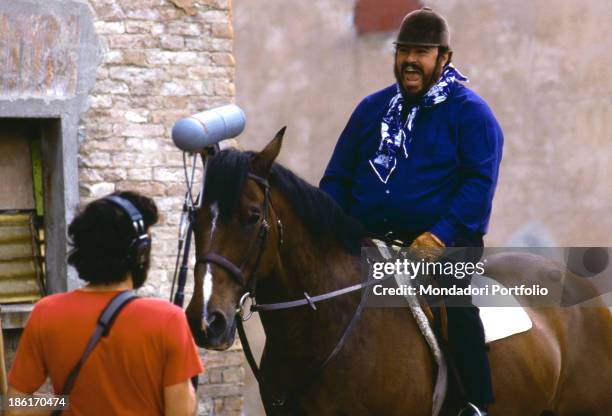 Italian tenor Luciano Pavarotti singing seated on horseback. Modena, 1970s.