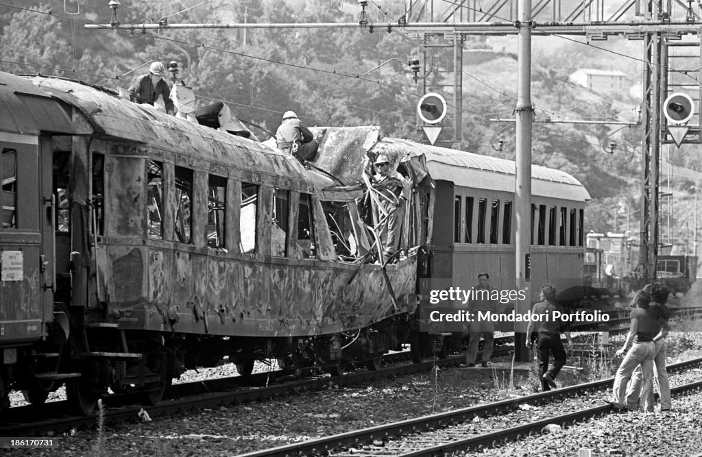A group of firemen and volunteers at work on a gutted wagon after the Italicus E