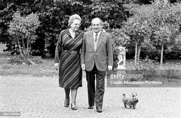Italian entrepreneur and president of Confindustria Luigi Lucchini walking in the garden of his house with his wife Emilia Rota and their Yorkshire...