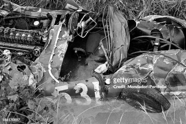 The remains of the Ferrari destroyed during the Mille Miglia Automobile Race. Spanish racing driver Alfonso de Portago , American navigator Edmund...