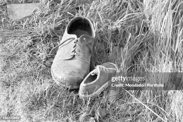 Two shoes left in the grass after the accident during the Mille Miglia Automobile Race. Spanish racing driver Alfonso de Portago , American navigator...