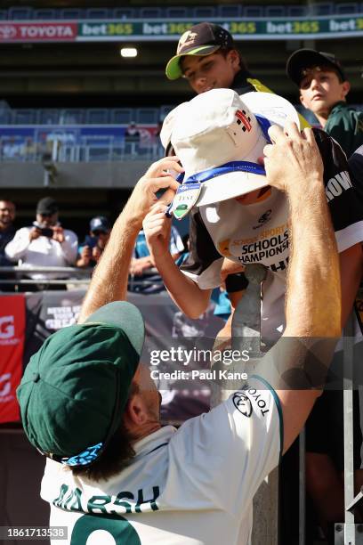 Mitchell Marsh of Australia gives his 'Player of the match' medal to a spectator after Australia's victory during day four of the Men's First Test...