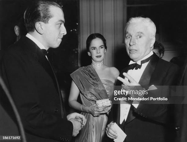The Italian christian Democrat politician Giulio Andreotti converses with the British actor Charlie Chaplin on the occasion of a party organized at...