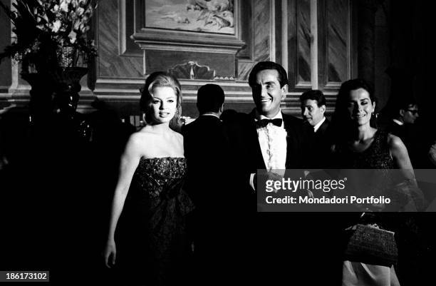 Italian actor and director Vittorio Gassman smiling beside beside British actress Margaret Lee and French actress Juliette Mayniel. Vittorio Gassman,...