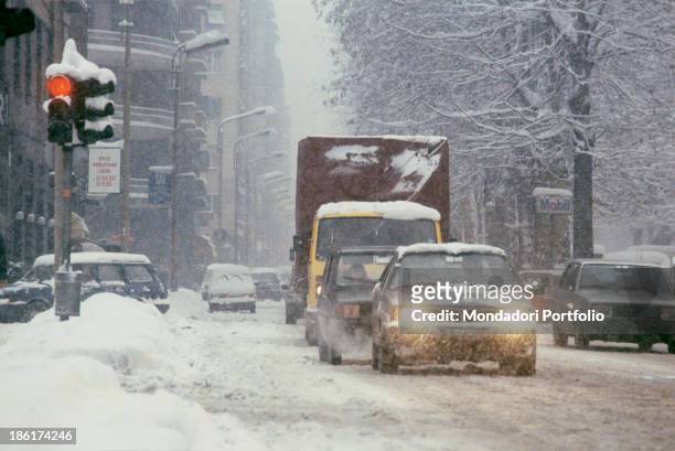 Vehicles going through the streets covered by the snow. One hundred and forty million cubic meters of snow fell in the city between Sunday 13th and...