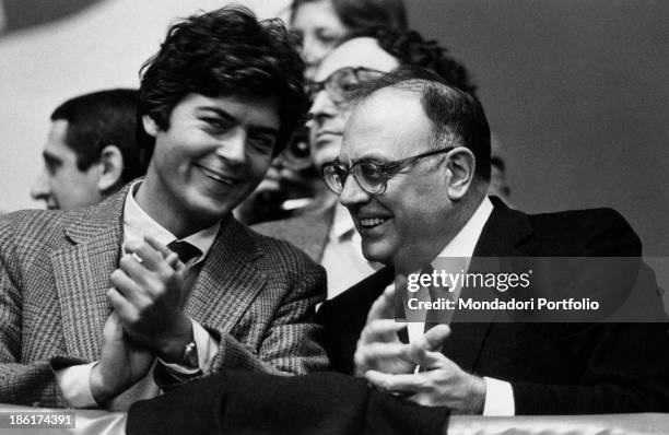 Socialist politicians Claudio Martelli, on the left, and his friend Rino Formica, on the right, are clapping their hands, joking together after a...