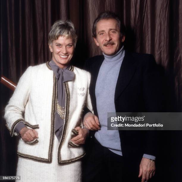 Italian baroness and singer Alida Valli smiling beside Italian singer-songwriter, guitarist and actor Domenico Modugno. 1981.