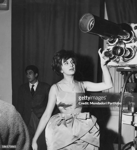 Italian singer Mina touching a camera at 10th Sanremo Music Festival. Sanremo, January 1960.