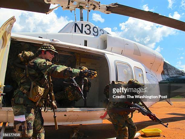 Special Forces soldier instructs South Sudanese commandos on how to quickly exit a helicopter at a U.S.-run base in Nzara, South Sudan.